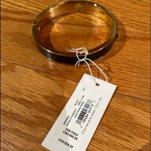 NWT - Kate Spade “Hole Punch Spade” bracelet in enamel black w/dust bag.